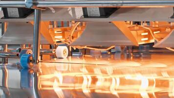 Close-up shot of a large-scale machine for the packaging of metal sheets in the process of panel production. Slow motion video