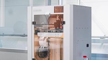 Movable part of the 3D printer produces a part according to a pre-defined design. Technologies of the future. Medium shot. Slow motion. video