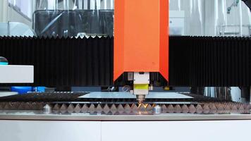 Operation of a sophisticated automated machine designed for laser cutting metal in industrial settings. Medium shot. Slow motion. video