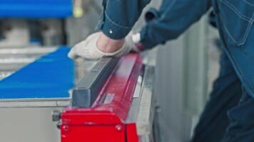 Two workers use a sheet-bending press to give the metal sheet the required shape. Slow motion. Close up. video