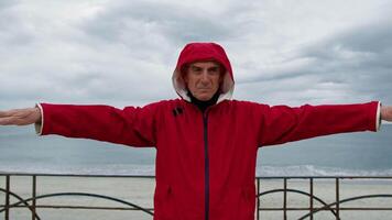 Man Stretching With The Raincoat On video