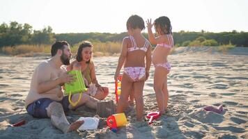 Sunlight Over A Family Playing At The Beach video
