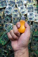 pile of electronic waste on factory floor is circuit board of mobile phone waiting to be processed extract gold to separate precious metal from electronic waste. extracting precious metal from e-waste photo