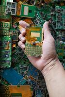 pile of electronic waste on factory floor is circuit board of mobile phone waiting to be processed extract gold to separate precious metal from electronic waste. extracting precious metal from e-waste photo