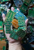 pile of electronic waste on factory floor is circuit board of mobile phone waiting to be processed extract gold to separate precious metal from electronic waste. extracting precious metal from e-waste photo