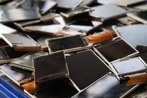 damaged LCD screens of mobile phones are collected as electronic waste waiting for valuable metals inside LCD screens be sorted for reuse reducing e-waste in nature and increasing value of e-waste. photo