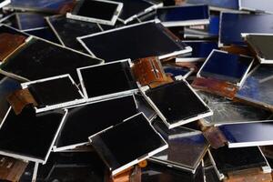 damaged LCD screens of mobile phones are collected as electronic waste waiting for valuable metals inside LCD screens be sorted for reuse reducing e-waste in nature and increasing value of e-waste. photo
