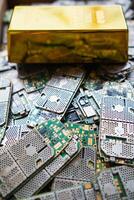 pile of electronic waste on factory floor is circuit board of mobile phone waiting to be processed extract gold to separate precious metal from electronic waste. extracting precious metal from e-waste photo