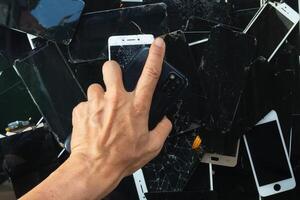 damaged LCD screens of mobile phones are collected as electronic waste waiting for valuable metals inside LCD screens be sorted for reuse reducing e-waste in nature and increasing value of e-waste. photo