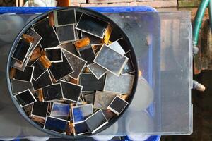 damaged LCD screens of mobile phones are collected as electronic waste waiting for valuable metals inside LCD screens be sorted for reuse reducing e-waste in nature and increasing value of e-waste. photo