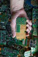 pile of electronic waste on factory floor is circuit board of mobile phone waiting to be processed extract gold to separate precious metal from electronic waste. extracting precious metal from e-waste photo