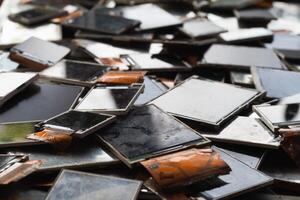 damaged LCD screens of mobile phones are collected as electronic waste waiting for valuable metals inside LCD screens be sorted for reuse reducing e-waste in nature and increasing value of e-waste. photo