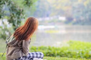 Blurred image,A woman waits for her lover alone on the aisle in the park in the evening to discuss common problems. The idea of waiting alone in hope photo
