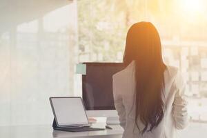 A businesswoman is using a laptop to communicate and check work from home online because she is starting a business that can order and check from anywhere online.online business ideas photo