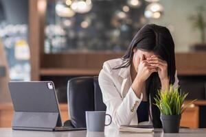 businessman sitting in an office expressing concern as the financial institution has filed for bankruptcy due to lost business and unable to repay the loan to the financial institution as promised. photo