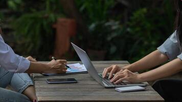 young businesswoman is reviewing results of corporate network via laptops and the Internet in order to prepare documents for meetings to give investors confidence in doing business. photo