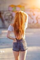Blurred image, the back of a woman standing alone waiting for her lover in the morning on the blurred background of the beautiful sunrise. The idea of waiting with hope is all alone. photo