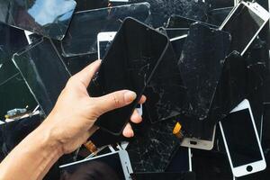 damaged LCD screens of mobile phones are collected as electronic waste waiting for valuable metals inside LCD screens be sorted for reuse reducing e-waste in nature and increasing value of e-waste. photo