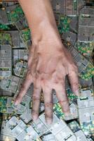 pile of electronic waste on factory floor is circuit board of mobile phone waiting to be processed extract gold to separate precious metal from electronic waste. extracting precious metal from e-waste photo