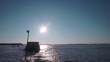 View of cargo floating behind boat on river. Clip. River cargo tug is sailing on background of sunny sky. Tractor boat pulls barge with cargo along river. Timelapse video