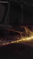Welder complete with personal protective equipment is perform pipe welding in dark area using Automatic Welding System. Welding sparks spreading everywhere. Automat welding pipe production video