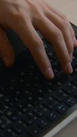 Close-up of man typing on keyboard. Stock footage. Man types beautifully with his hands on laptop keyboard. Man is working on laptop and typing on keyboard in cafe video