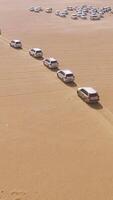 4x4 SUVs cars driving through the sand dunes in the desert of Abu Dhabi. Stock. Top view on SUVs in the desert video