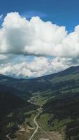 Mountain green range in clouds landscape. Top view of the mountains with sky and clouds video