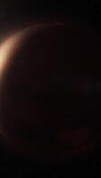 View of realistic atmosphere of space, twinkling stars and planet slowly rotating illuminated by sun on left side. View of planet illuminated video