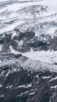 Alps cold mountain slopes. Creative. Snow and ice covered cliffs and rocks. video