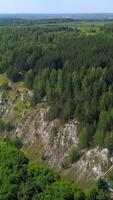 Mountains above the river. Clip.The view from the height of the green forests and the river below and the temple standing in the distance and the blue daytime sky are visible. video