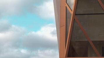 Top view of architecture of modern windows of building with reflection. Stock footage. Reflection of sky in windows of modern office building. Stylish architecture of modern building with reflection video