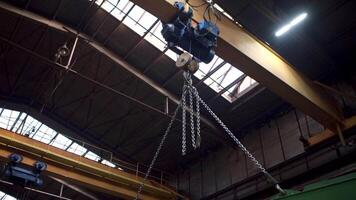 Large metal construction of an industrial crane transporting details. Clip. Heavy machinery background at the factory. video