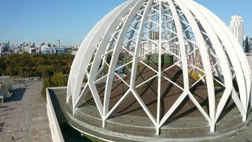 Aerial view of an unusual building with a spherical structure looking like a dome. Stock footage. Concept of architecture. video
