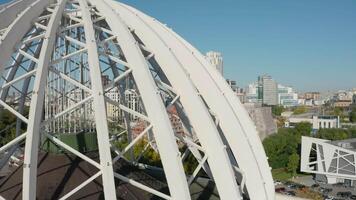 Top view of domed structure with beams. Stock footage. Beautiful architecture of metal dome with beams. Dome made of metal semi-arches with air space on background of modern city video