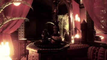 A room with candles and a table with a vase on it video