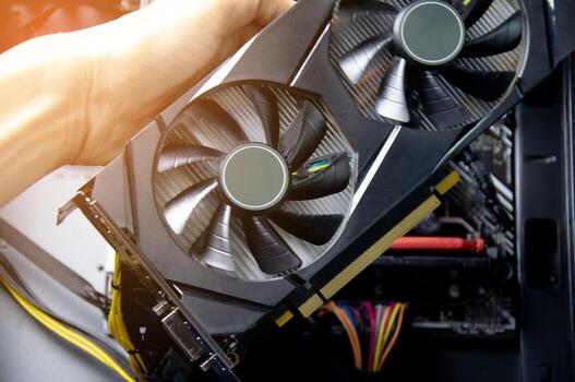 Technician repairing computer Change the graphics card in the computer. photo