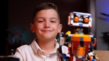 Young engineer smiling with his robot creation photo