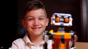 Young engineer smiling with his creation robot from constructor toy photo