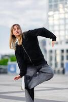 Young Dancer Performing Dynamic Moves in Urban Space During Late Afternoon photo