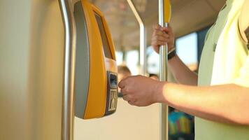 Easy payment for transportation. Man hand passenger taking ticket in public transport tram or bus, using vending tickets machine video