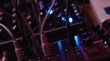 Sound engineer connecting cables and turning knobs on audio synthesizers video
