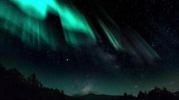 Aurora Borealis interweaving with the Milky Way Galaxy. Northern Lights Time Lapse Solar Wind. Dance of Celestial Lights. Northern Lights twirling with solar wind flaring in green and purple video