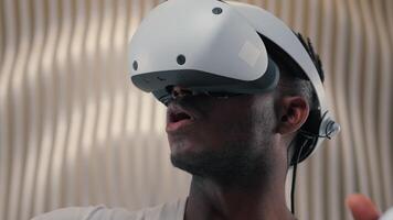 3d world gaming African American man male guy using controllers VR helmet virtual augmented reality glasses high-tech Internet technology futurism cyber game interface playing innovation metaverse video