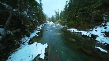 FPV drone flight over the fast moving river with rapids, close to the water. video