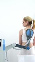 A physiotherapist administers advanced electromagnetic therapy for back pain relief using state-of-the-art equipment. Ideal for showcasing effective pain management and rehabilitation techniques video