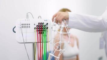 Close-up of a doctor handling EEG sensors, highlighting precision and care in advanced diagnostic procedures. Ideal for showcasing modern medical technology and professional expertise. video
