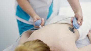 Using electromagnetic super inductive system to recover from shoulder injuries. Going to SIS therapies for muscle relaxation. Recovery from trauma and rheumatic pathologies in a physiotherapy clinic video