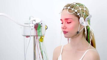 A doctor places EEG sensors on a young patient's head for brain testing in a medical center. Ideal for showcasing advanced diagnostics and professional healthcare settings. video