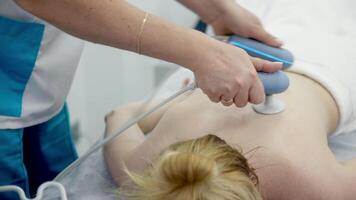 Using electromagnetic super inductive system to recover from shoulder injuries. Going to SIS therapies for muscle relaxation. Recovery from trauma and rheumatic pathologies in a physiotherapy clinic video